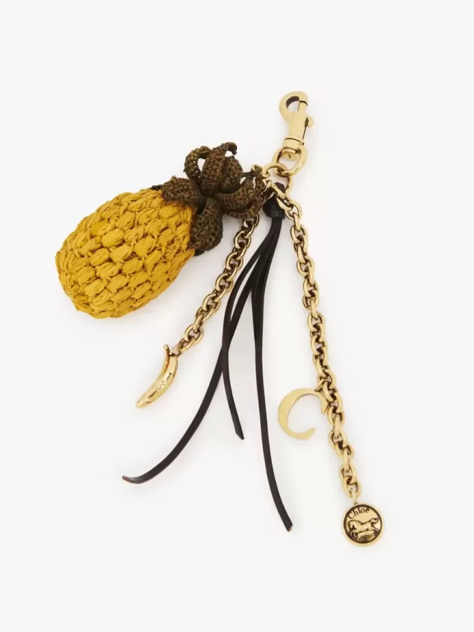 Bijou de sac ananas en raphia, métal et cuir