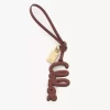 Bijou de sac logo en cuir brillant Bijou de sac logo en cuir brillant